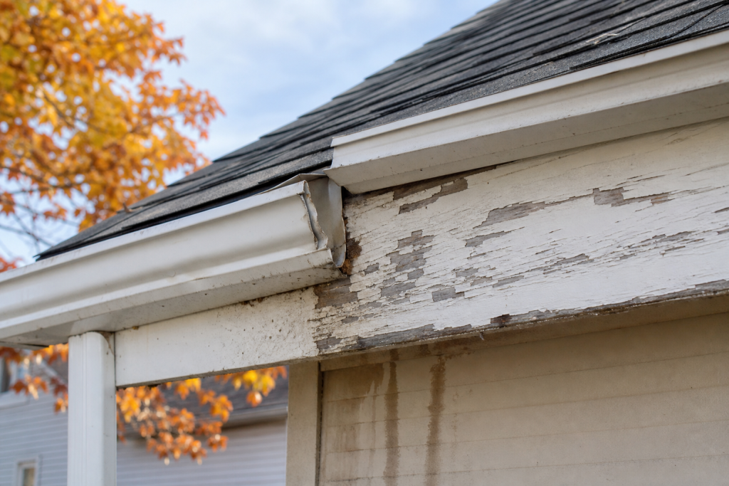 Weathered fascia board and sagging gutter section on a Central Ohio house, the kind of damage that leads to soffit and fascia repair · AI-generated illustrative photo