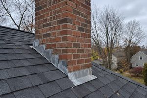 Brick chimney and step flashing on an asphalt shingle roof in Central Ohio